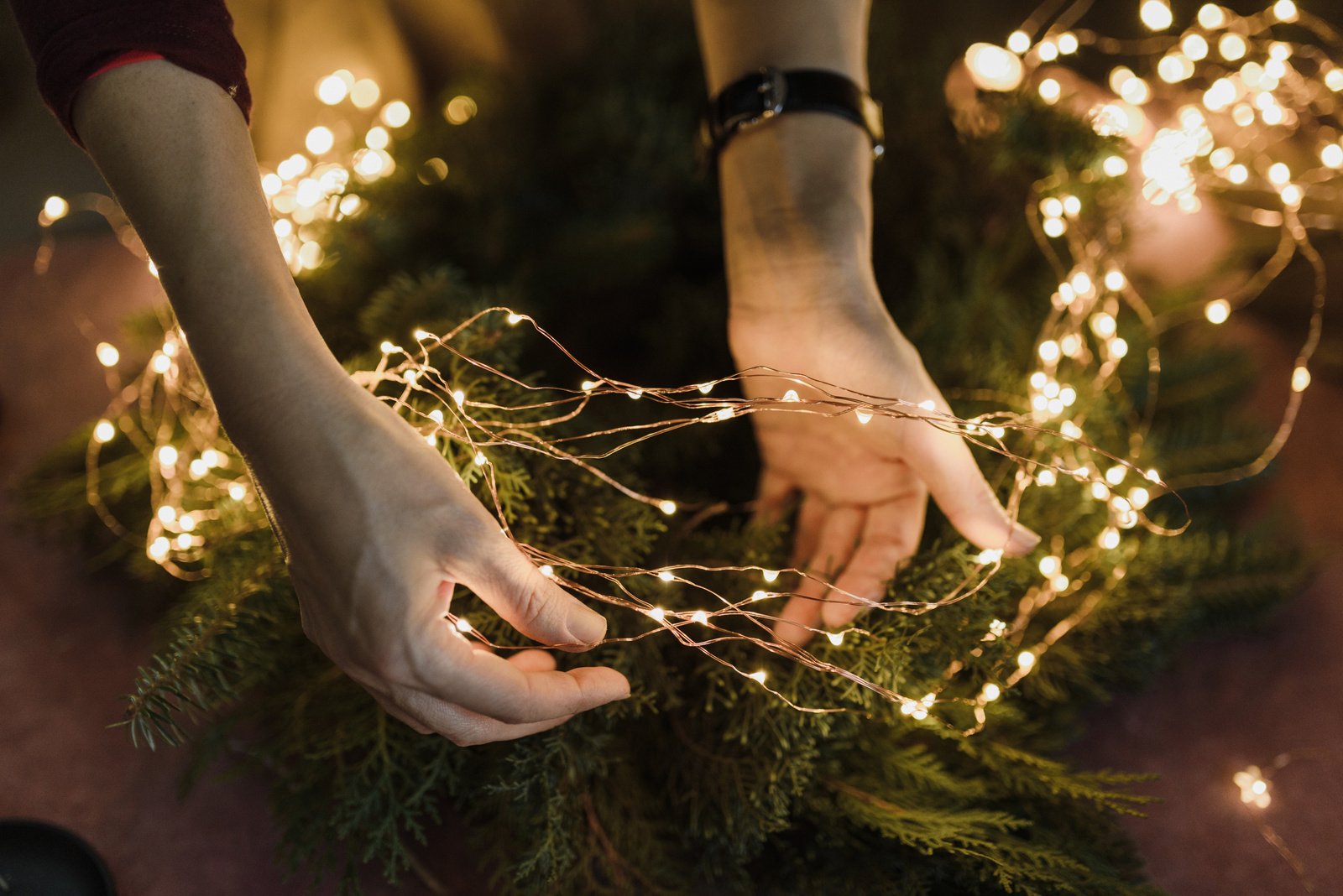 Hands Holding Christmas Lights